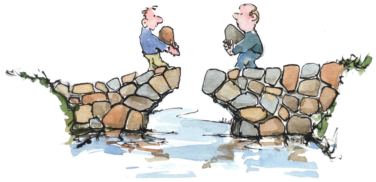 Two people build a rock bridge from their respective sides and they are about to place the last rocks to complete it.